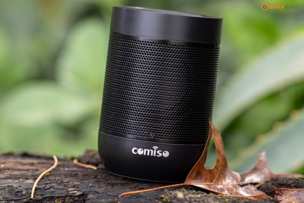 Comiso X26M outside on a wood log with autumn leaf