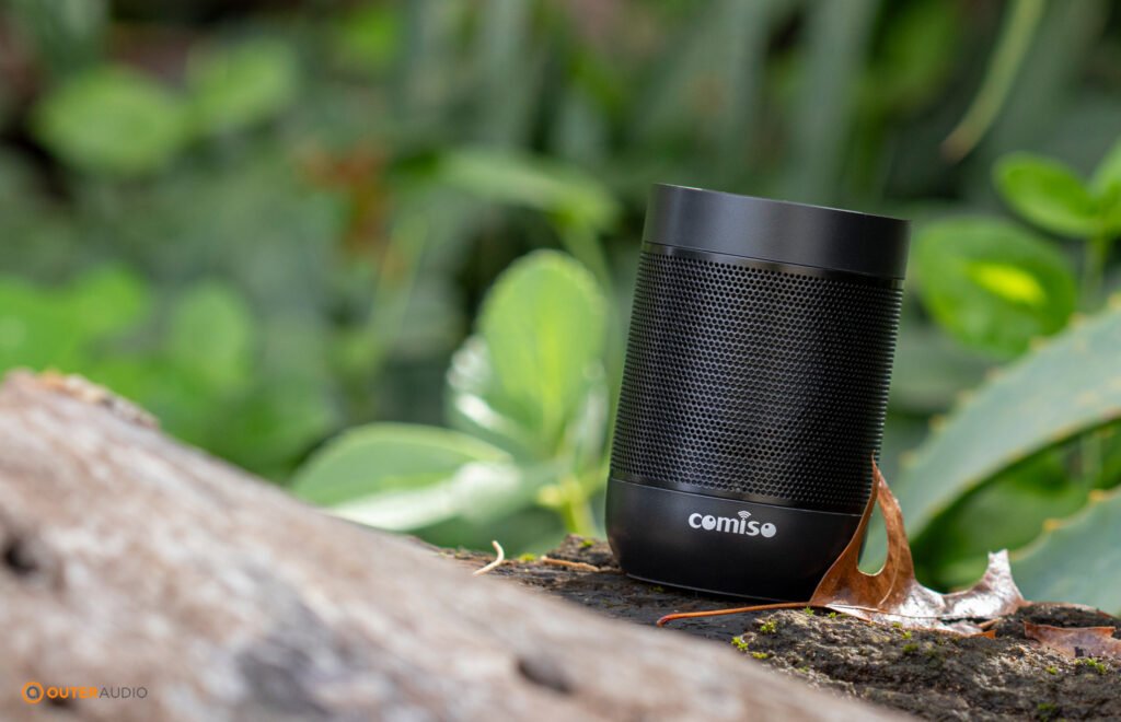 Comiso X26M Speaker outdoors with green foliage in background
