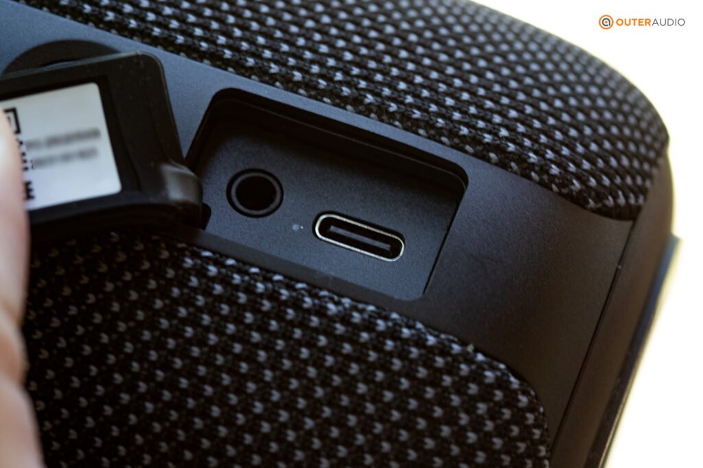 Tribit Stormbox Mini with the protective charging port flap pulled back