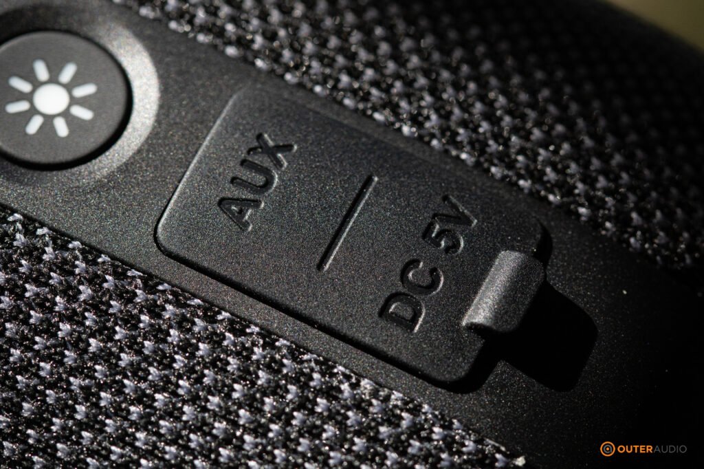 The sealed port area, showing the aux and DC charging text